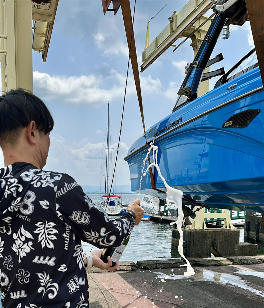CENTURION BOAT Ri237 2020modelの船体にシャンパンをかける男性